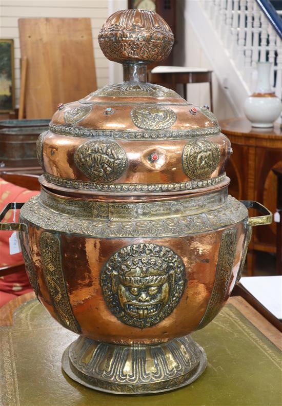 A large South East Asian copper and brass vessel with semi precious stone mounts height 75cm approx.
